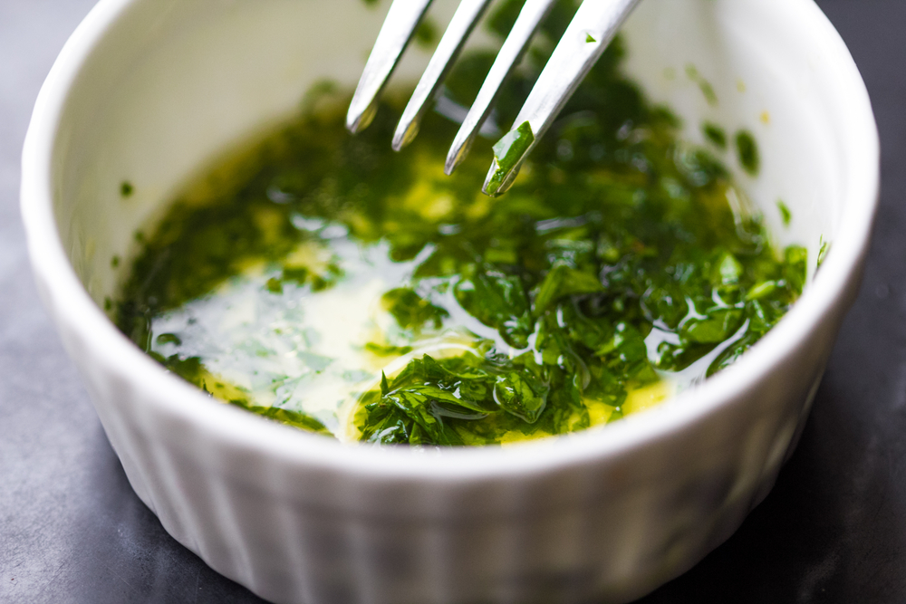 Fresh salad dressing of olive oil, lemon juice, cilantro and herb parsley